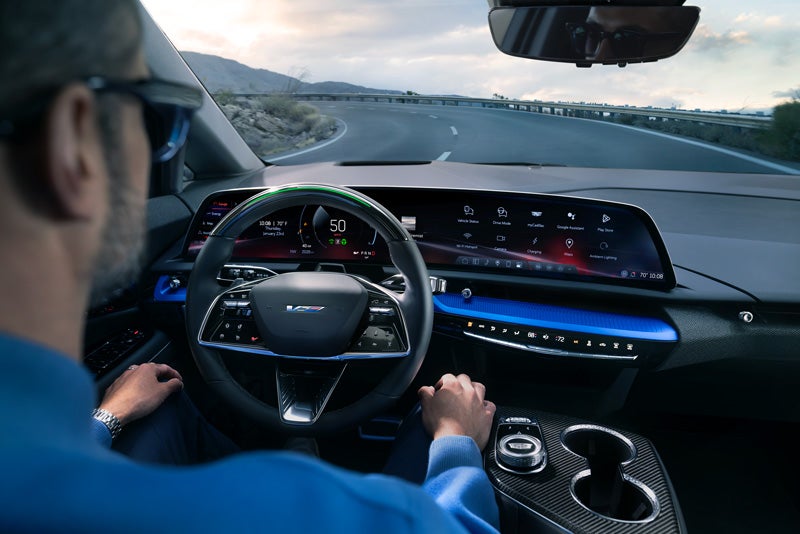 Front View of the 2026 OPTIQ-V Driving Through the Dusk Utilizing its Headlights | Randy Marion Cadillac in Mooresville NC